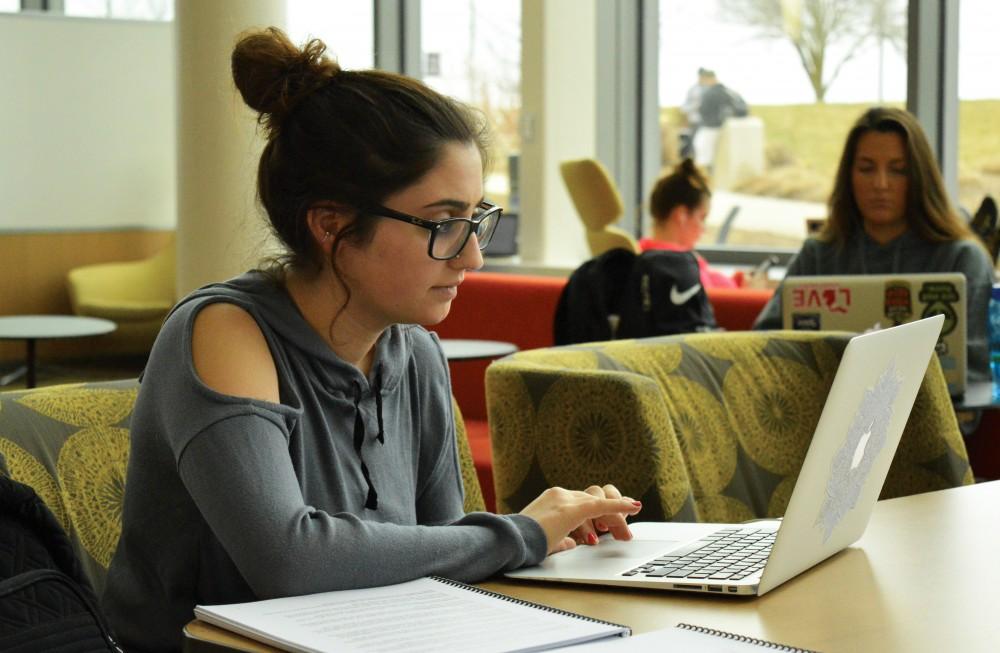 GVL/Hannah Zajac - Junior Theraputic Recreation student Angela Thweni works on finishing homework in the Mary Idema Pew Library on Wednesday, March 29, 2017.