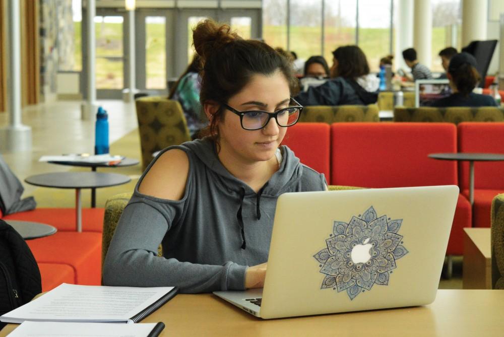 GVL/Hannah Zajac - Junior Theraputic Recreation student Angela Thweni works on finishing homework in the Mary Idema Pew Library on Wednesday, March 29, 2017.