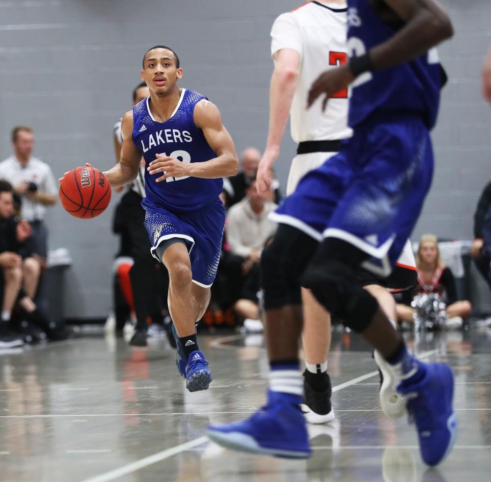 GVL/Kevin Sielaff - Myles Miller (12) carries the ball up the court during the game versus Findlay at the University of Findlay on Tuesday, Feb. 28, 2017.