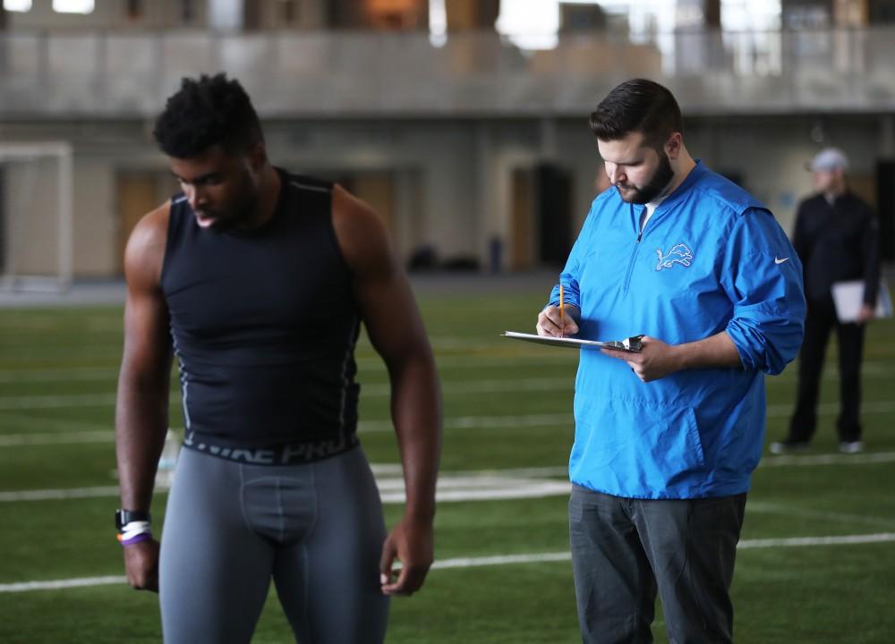 GVL/Kevin Sielaff - Sydney Omameh reviews his broad jump results during Pro Day inside the Kelly Family Sports Center on Monday, Mar. 20, 2017.