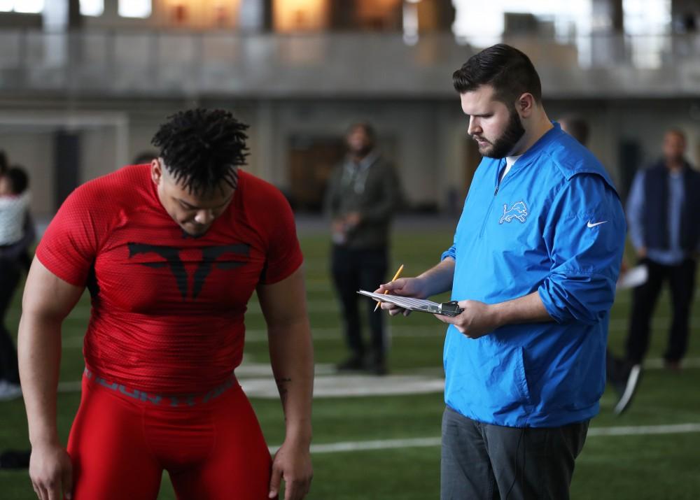 GVL/Kevin Sielaff - DéOndre Hogan reviews his broad jump results during Pro Day inside the Kelly Family Sports Center on Monday, Mar. 20, 2017.