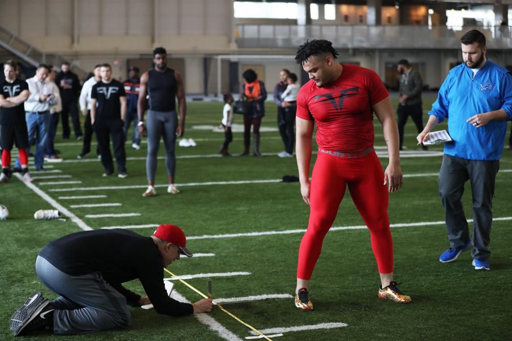 GVL/Kevin Sielaff - DéOndre Hogan reviews his broad jump results during Pro Day inside the Kelly Family Sports Center on Monday, Mar. 20, 2017.