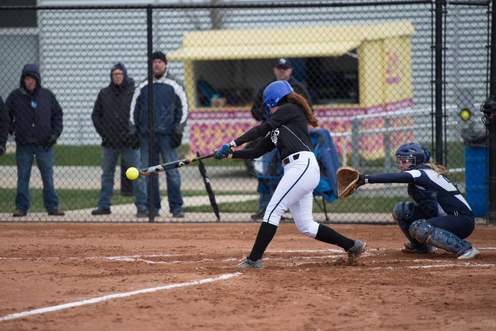 GVL/Kevin Sielaff - Jenna Lenza (4) drops her bat after hitting in a couple runs during the game vs. Lewis on Tuesday, March 28, 2017.