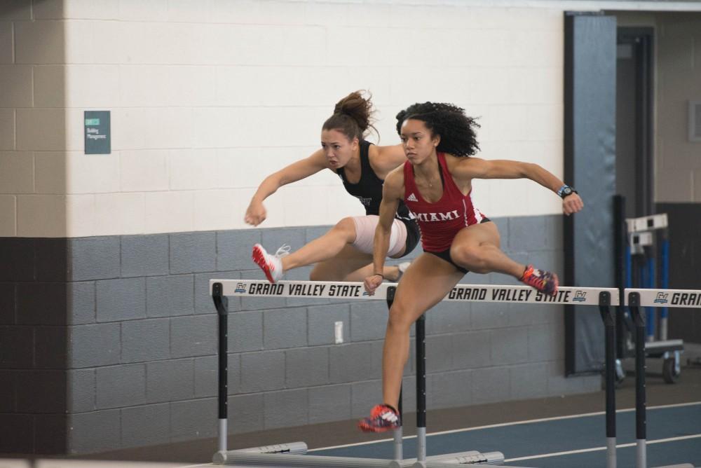 GVL / Luke Holmes - Breanna Luba jumps over the hurdle. The GVSU Big Meet was held in the Kelly Family Sports Center on Friday, Feb. 10, 2016.