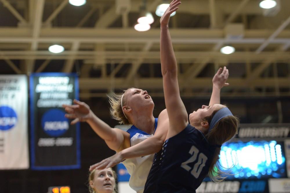 GVL / Luke Holmes - Piper Tucker (11) tries to take the ball up over her defender. GVSU Women’s Basketball defeated Northwood in the Fieldhouse Arena on Tuesday, Feb. 28, 2016.