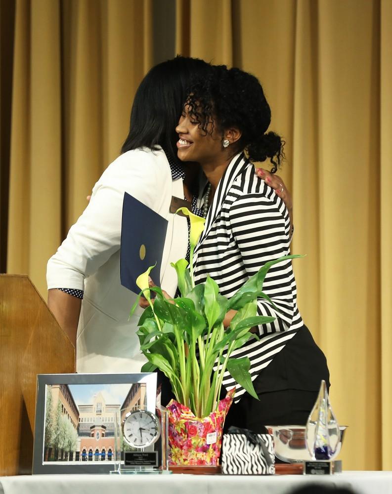 GVL/Kevin Sielaff - Kari Bonner (right) receives one of the three Positive Black Women Scholarship Awards during the Women's Commission Awards inside the Kirkhof Center on Thursday, March 30, 2017.