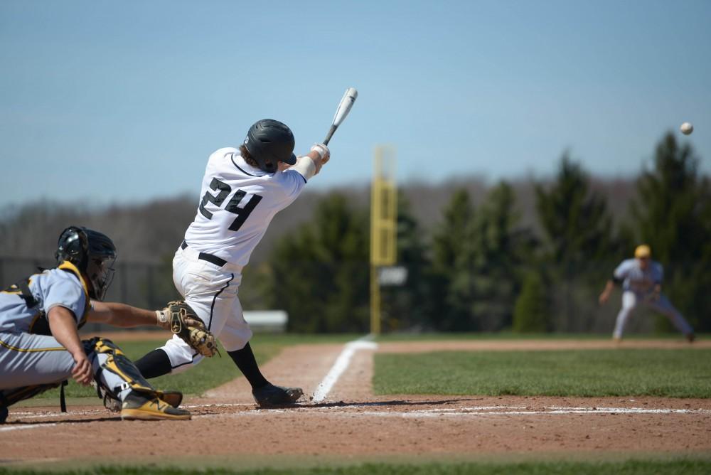 GVL / Luke Holmes -  Austin LaDoux (24) hits the ball. GVSU Men's Baseball faced off against Ohio Dominican in a double header on Saturday, April 8, 2017.