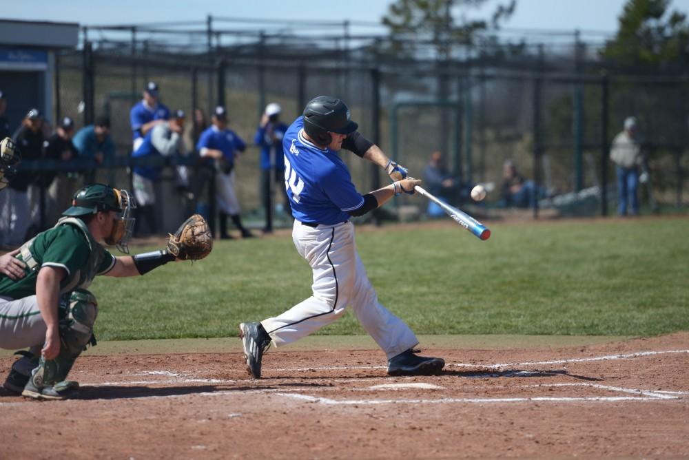 GVL / Luke Holmes - Austin LaDoux (24) makes solid contact with the ball. GVSU Men’s Baseball played a double-header against Tiffin University on Saturday, April 1, 2016.