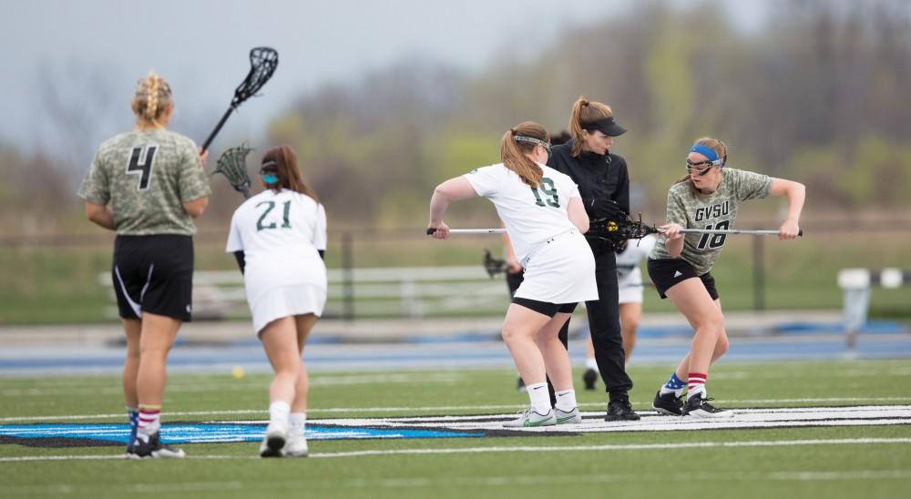 GVL / Kevin Sielaff - Meghan Datema (18) takes the first face off of the game. Grand Valley defeats Lake Erie College with a final score of 19-2 on Friday, April 29, 2016 in Allendale. 