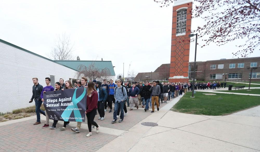 GVL/Kevin Sielaff - Grand Valleys Interfraternity Council holds a silent march around campus against sexual assault on Tuesday, April 11, 2017.