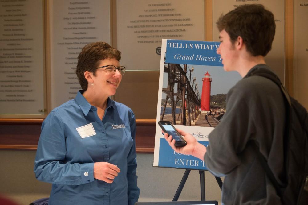 GVL / Luke Holmes - Julie Cowie speaks with a student. The Civic Engagement Showcase was held in the DeVos Center in downtown Grand Rapids on Thursday, April 13, 2017.