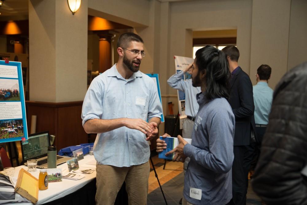 GVL / Luke Holmes - Youssef Darwich speaks with a student about the Sustainable Agriculture Project. The Civic Engagement Showcase was held in the DeVos Center in downtown Grand Rapids on Thursday, April 13, 2017.