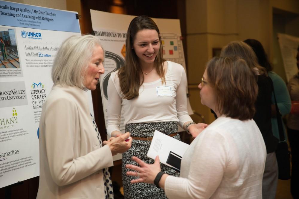 GVL / Luke Holmes - Sarah Culip speaks with colleagues about a refugee project. The Civic Engagement Showcase was held in the DeVos Center in downtown Grand Rapids on Thursday, April 13, 2017.