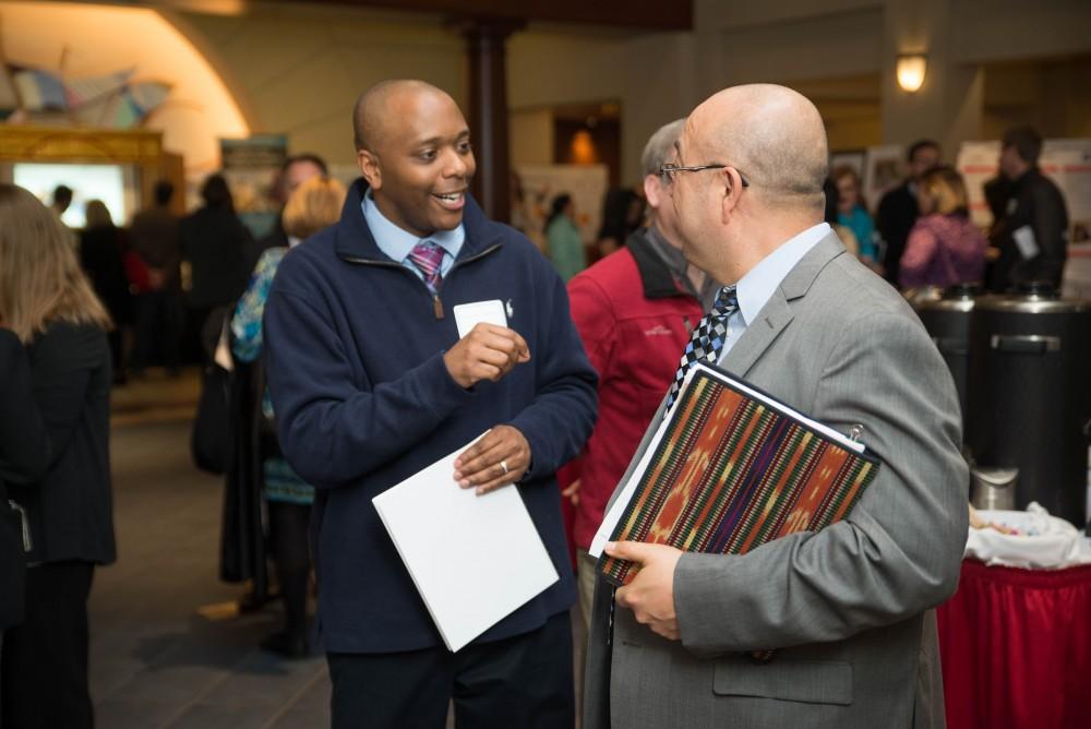 GVL / Luke Holmes - Preston Watkins speaks with a colleague. The Civic Engagement Showcase was held in the DeVos Center in downtown Grand Rapids on Thursday, April 13, 2017.