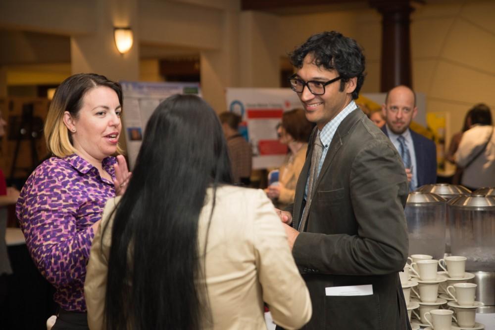 GVL / Luke Holmes - People have a grand ol' time chatting over some snacks. The Civic Engagement Showcase was held in the DeVos Center in downtown Grand Rapids on Thursday, April 13, 2017.