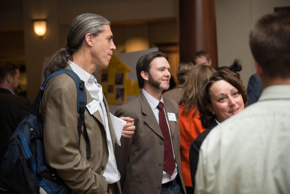 GVL / Luke Holmes - Donovan Anderson (left) speaks with his colleague, Jason Yancey (right). The Civic Engagement Showcase was held in the DeVos Center in downtown Grand Rapids on Thursday, April 13, 2017.