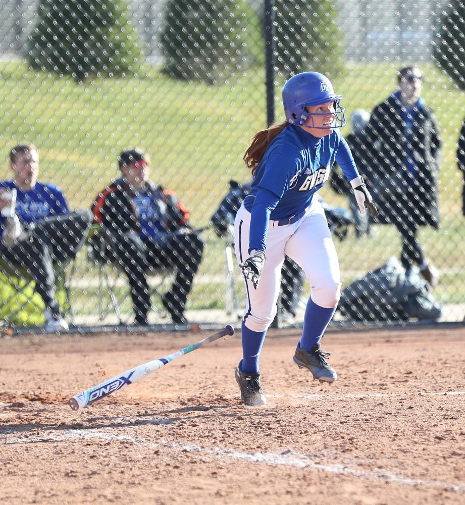 GVL/Kevin Sielaff - Jenna Lenza (4) drops her bat after hitting in a couple runs during the game vs. Lewis on Tuesday, March 28, 2017.