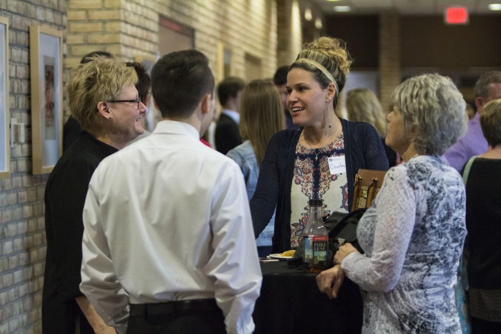 GVL/Mackenzie Bush - GVSU Student talks with family and friends. The Student Awards Convocation Ceremony was held in the Eberhard Center Monday, April 10, 2017. 