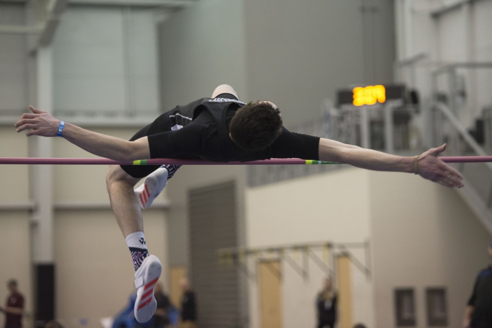 GVL / Luke Holmes - Hunter Weeks jumps over the pole. The GVSU Lints Alumni Meet was held in the Kelly Family Sports Center on Saturday, Jan. 29, 2017.