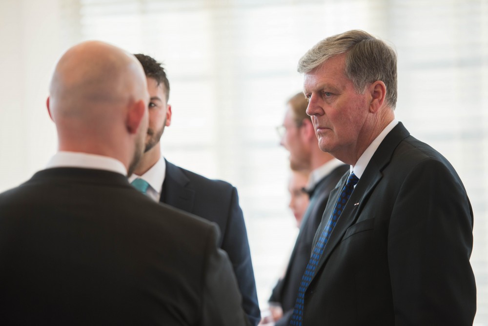 GVL / Luke Holmes -  President Haas talks to a couple of the attendees. The Student Veterans gala was held in the Alumni House on Saturday, April 8, 2017.