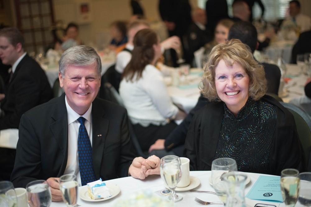 GVL / Luke Holmes -  Thomas and Marcia Haas enjoy cake after the dinner. The Student Veterans gala was held in the Alumni House on Saturday, April 8, 2017.