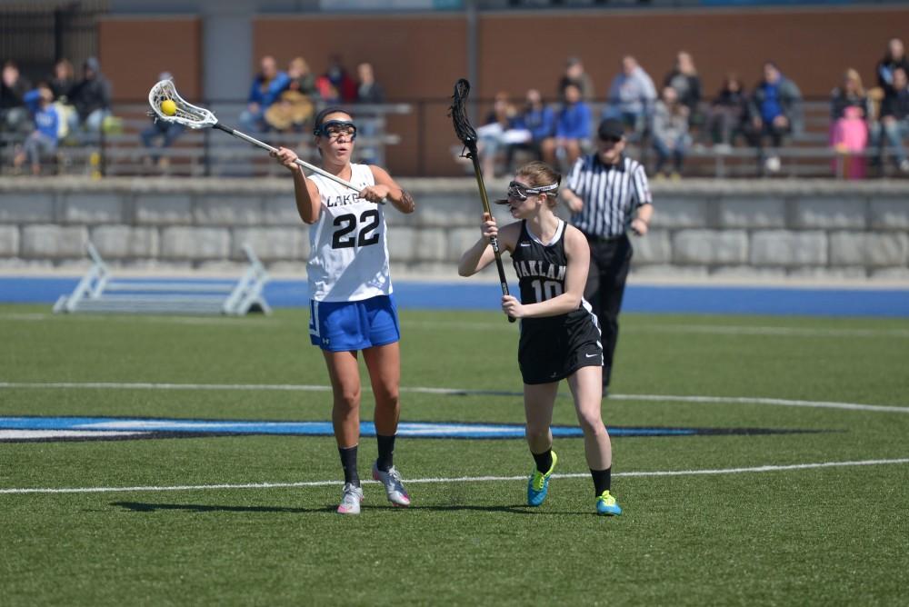 GVL / Luke Holmes - Karlee Hale (22) makes the pass. Women’s Lacrosse played against Oakland University on Saturday, April 1, 2016.