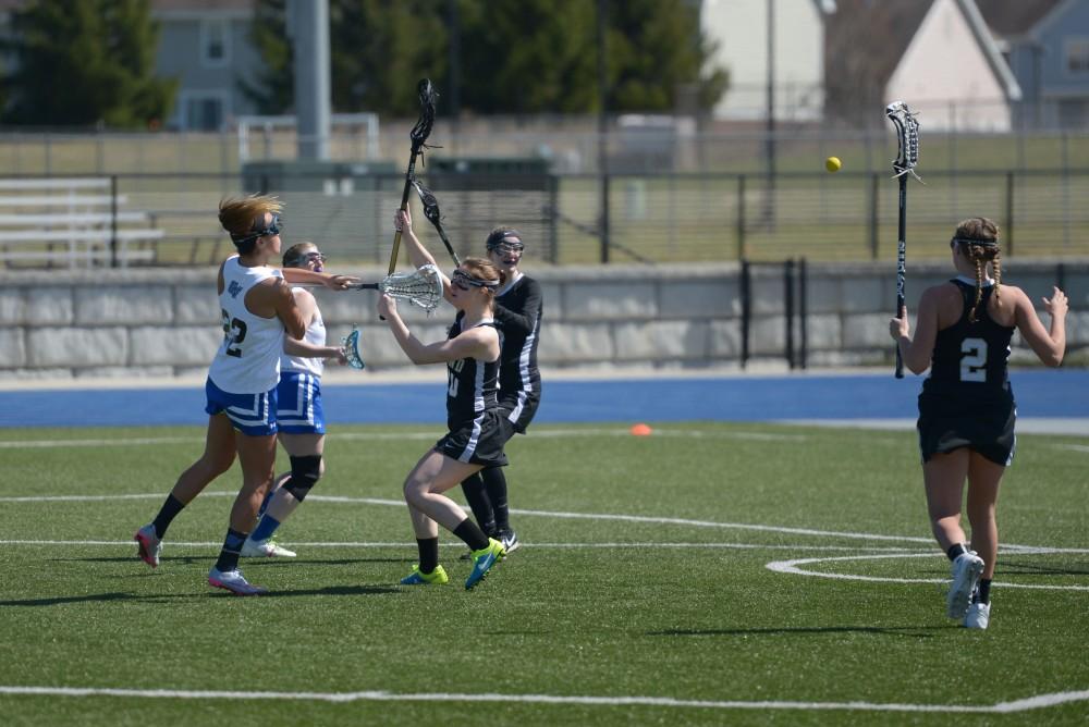 GVL / Luke Holmes - Karlee Hale (22) shoots the ball. Women’s Lacrosse played against Oakland University on Saturday, April 1, 2016.