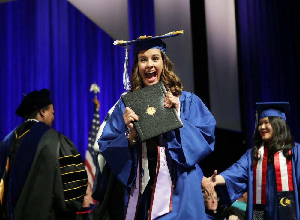 GVL / Emily Frye
Grand Valley State Univeristy student Brooke Bednar celebrates receiving her diploma during graduation on Saturday April 29, 2017.