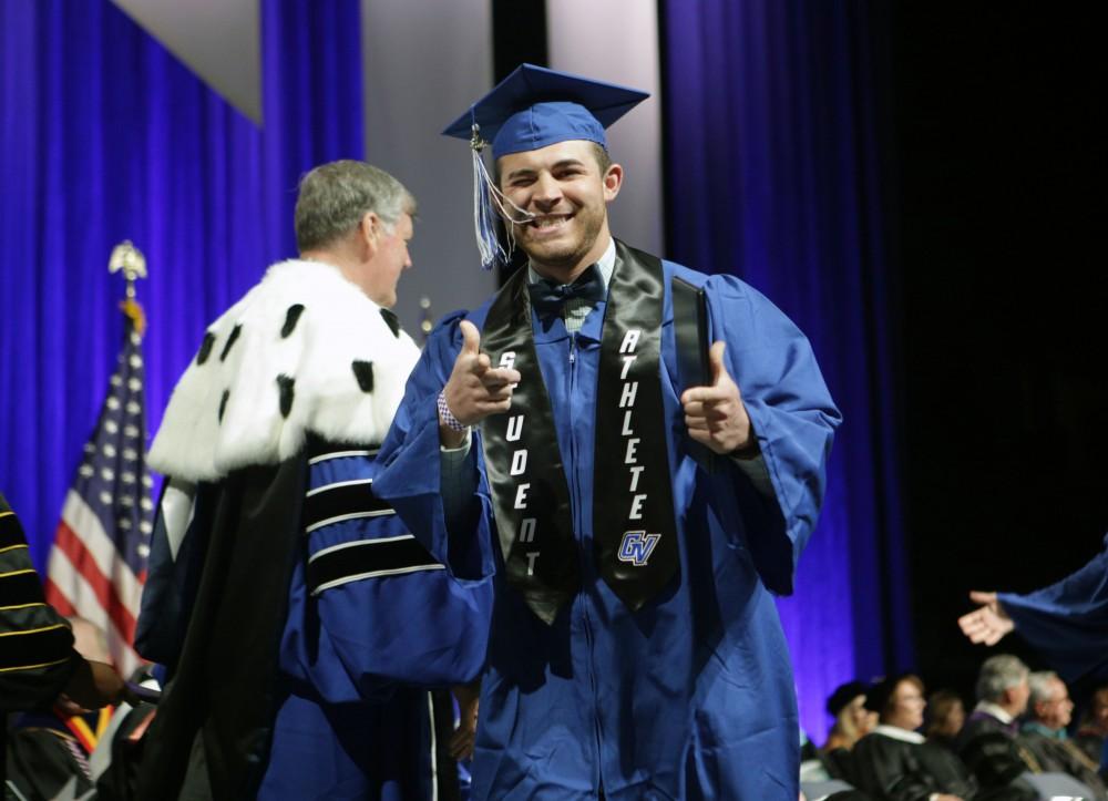 GVL / Emily Frye
Grand Valley State Univeristy football kicker Joel Skipper celebrates receiving his diploma during graduation on Saturday April 29, 2017.