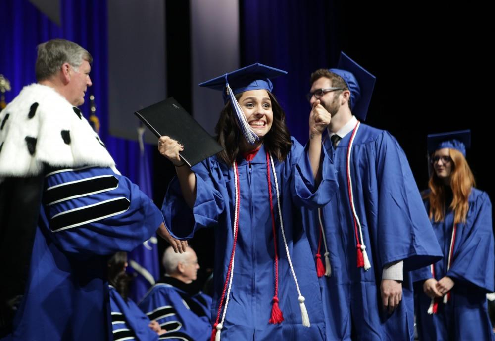 GVL / Emily Frye
Grand Valley State Univeristy student celebrates receiving her diploma during graduation on Saturday April 29, 2017.