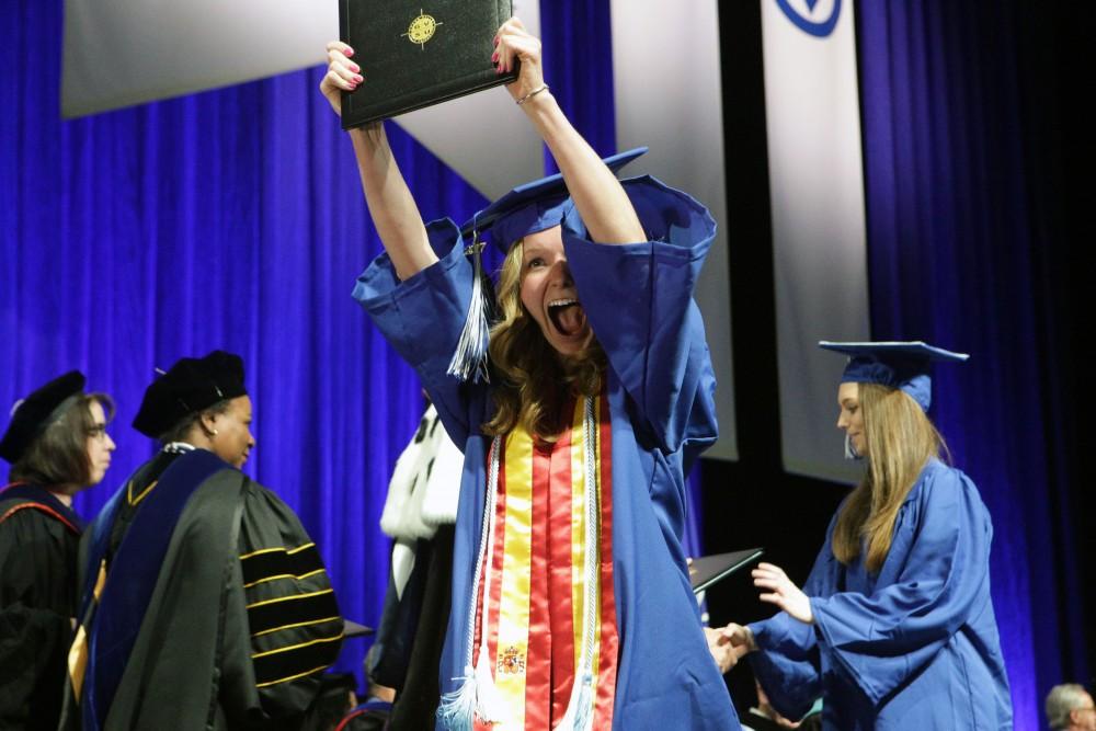 GVL / Emily Frye
Grand Valley State Univeristy education student Stephanie Smith celebrates receiving her diploma during graduation on Saturday April 29, 2017.