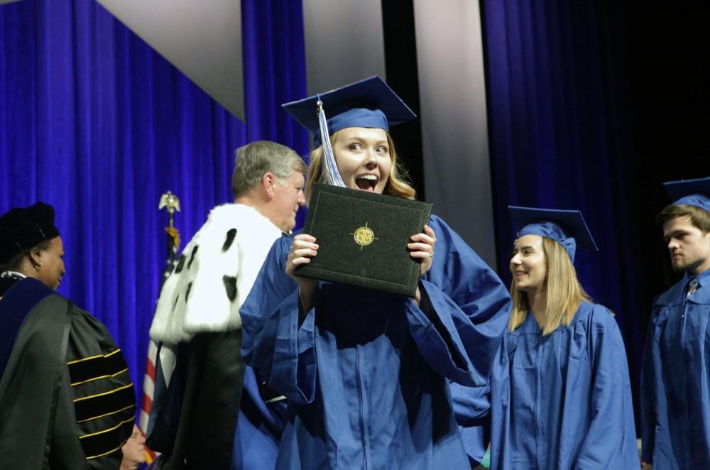 GVL / Emily Frye
Grand Valley State Univeristy Rachel Vogt celebrates receiving her diploma during graduation on Saturday April 29, 2017.