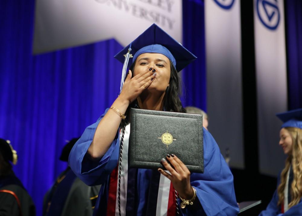 GVL / Emily Frye
Grand Valley State Univeristy journalism student Sanda Vazgec blows a kiss to her family in the crowd after receiving her diploma during graduation on Saturday April 29, 2017.