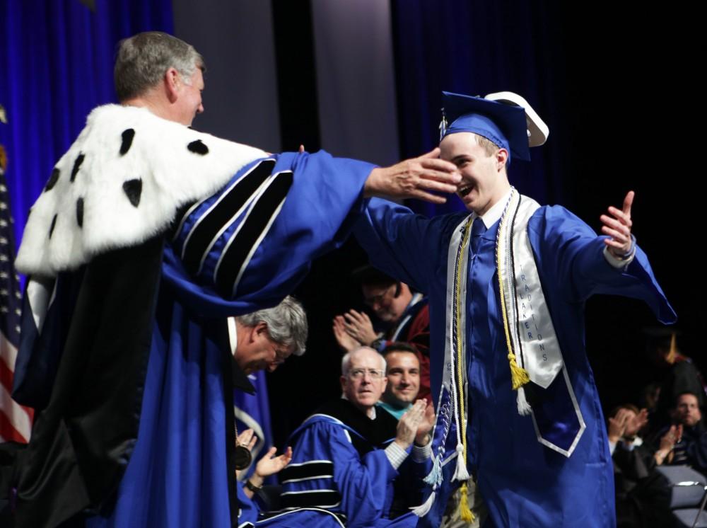 GVL / Emily Frye
Grand Valley State Univeristy student Sean O'Melia hugs President Haas after being the final student to graduate on Saturday April 29, 2017.