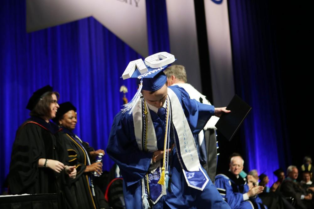 GVL / Emily Frye
Grand Valley State Univeristy student Sean O'Melia bows to the crowd during graduation on Saturday April 29, 2017.