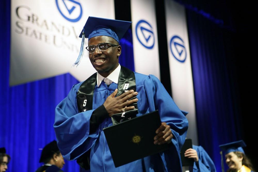 GVL / Emily FryeGrand Valley State Univeristy student celebrates receiving his diploma during graduation on Saturday April 29, 2017.