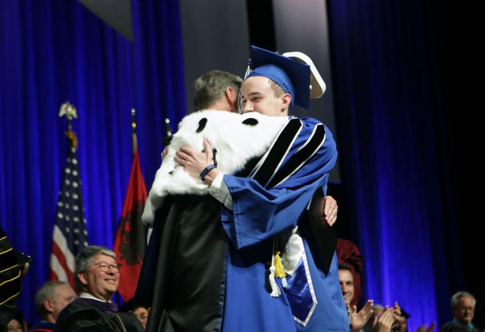 GVL / Emily FryeGrand Valley State Univeristy student Sean OMelia hugs President Haas during graduation on Saturday April 29, 2017.