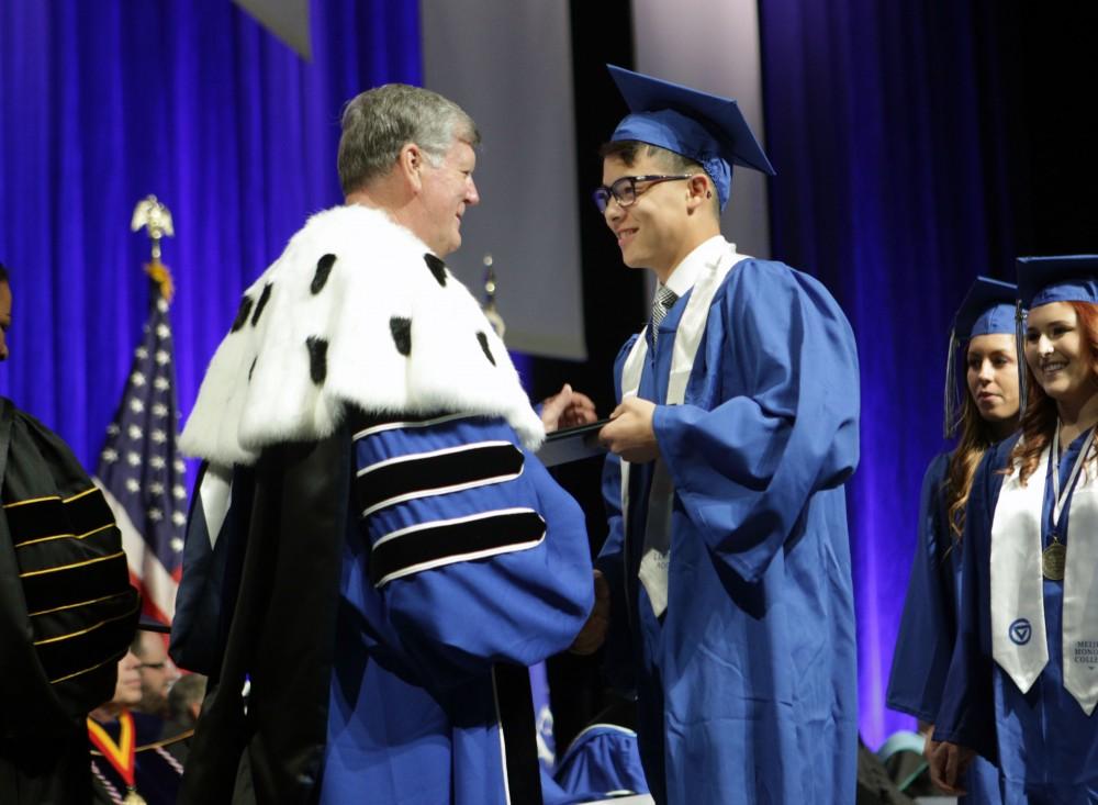 GVL / Emily FryeGrand Valley State Univeristy student Alex Wong receives his diploma during graduation on Saturday April 29, 2017.