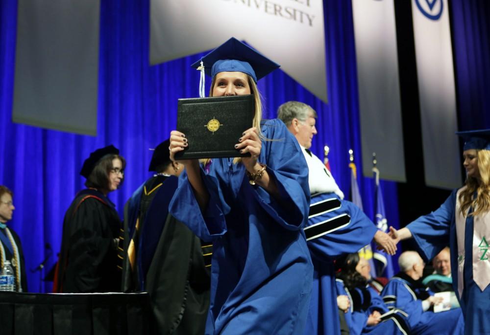 GVL / Emily FryeGrand Valley State Univeristy nursing student Holly Mossoian celebrates receiving her diploma during graduation on Saturday April 29, 2017.