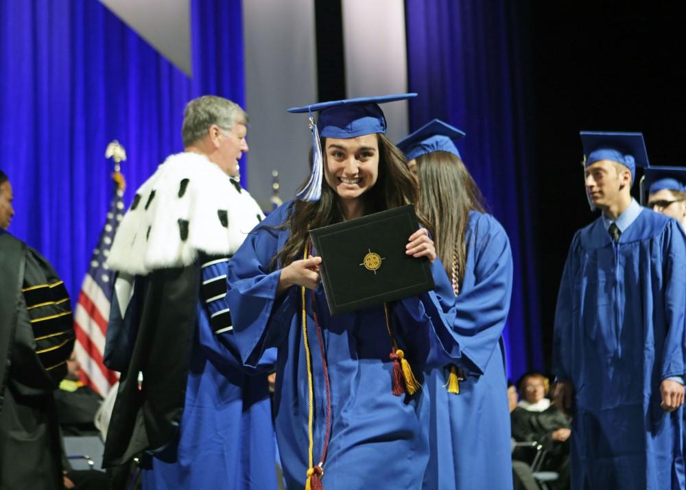 GVL / Emily FryeGrand Valley State Univeristy sonography student Caroline Insalaco celebrates receiving her diploma during graduation on Saturday April 29, 2017.