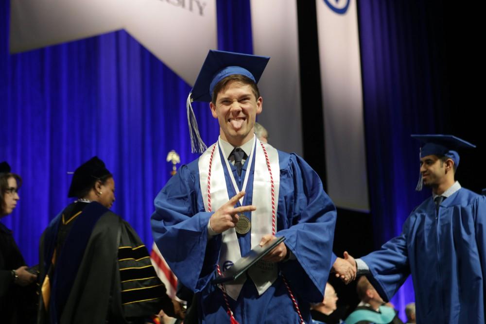 GVL / Emily FryeGrand Valley State Univeristy student Glenn Fitkin celebrates receiving his diploma during graduation on Saturday April 29, 2017.