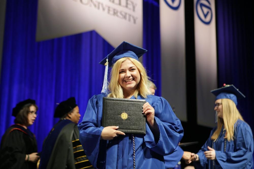GVL / Emily FryeGrand Valley State University student Hannah Lentz celebrates receiving her diploma during graduation on Saturday April 29, 2017.
