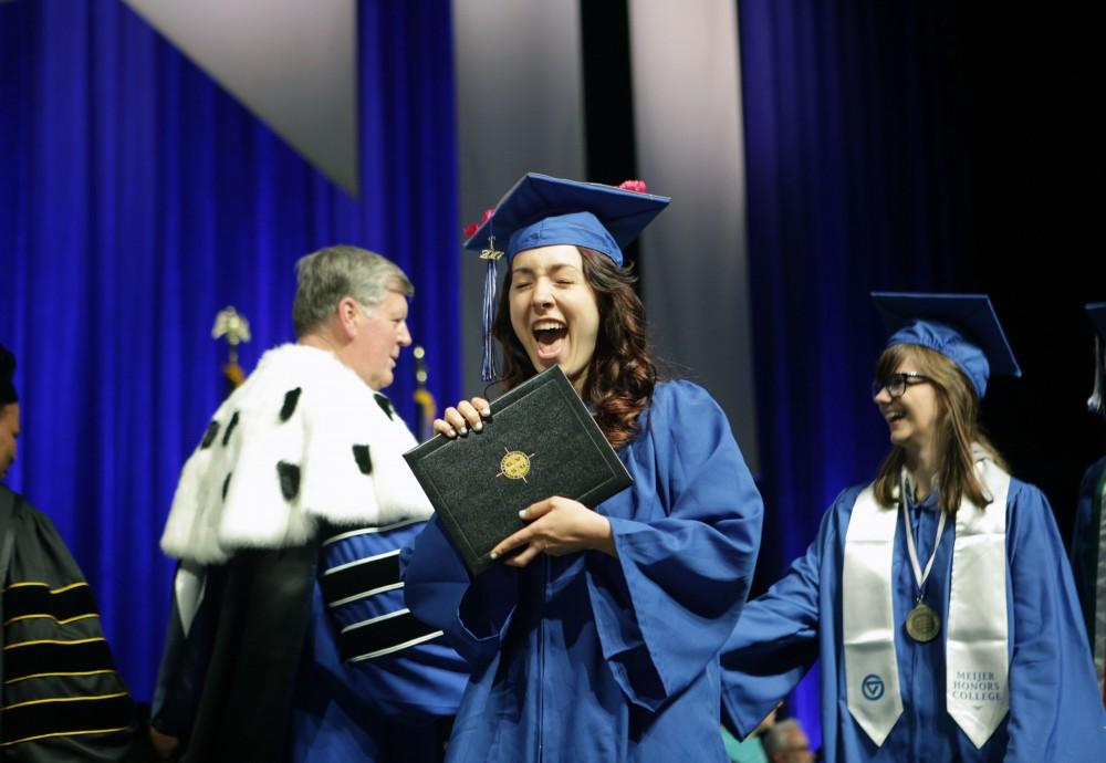 GVL / Emily FryeGrand Valley State University student Lyndsie Hosang celebrates receiving her diploma during graduation on Saturday April 29, 2017.