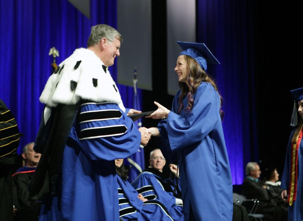 GVL / Emily FryeGrand Valley State University student receives her diploma during graduation on Saturday April 29, 2017.