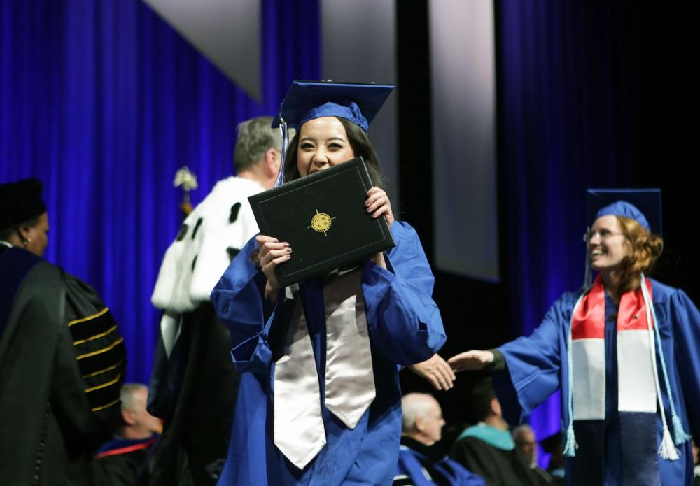 GVL / Emily FryeGrand Valley State University student celebrates receiving her diploma during graduation on Saturday April 29, 2017.