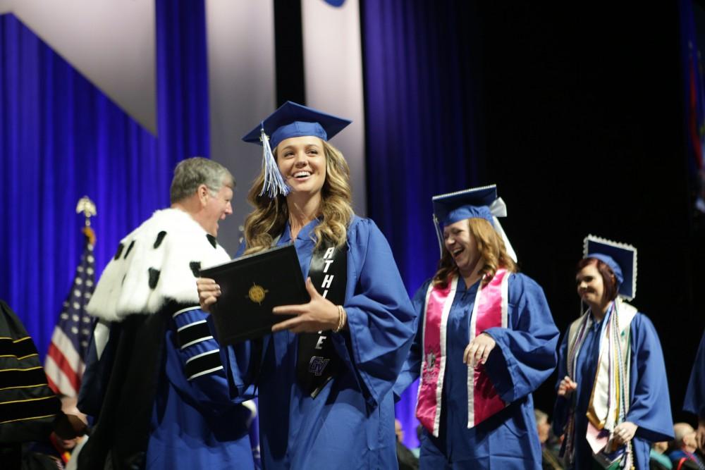 GVL / Emily FryeGrand Valley State University student Alex Taylor celebrates receiving her diploma during graduation on Saturday April 29, 2017.