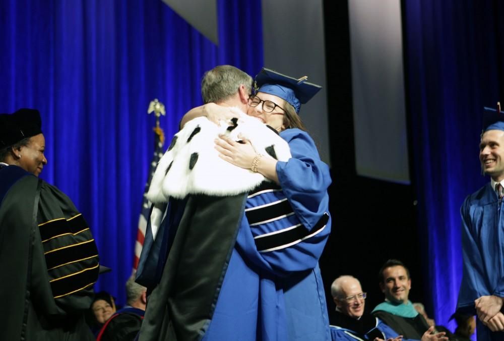 GVL / Emily FryeGrand Valley State University student hugs President Haas before receiving her diploma during graduation on Saturday April 29, 2017.