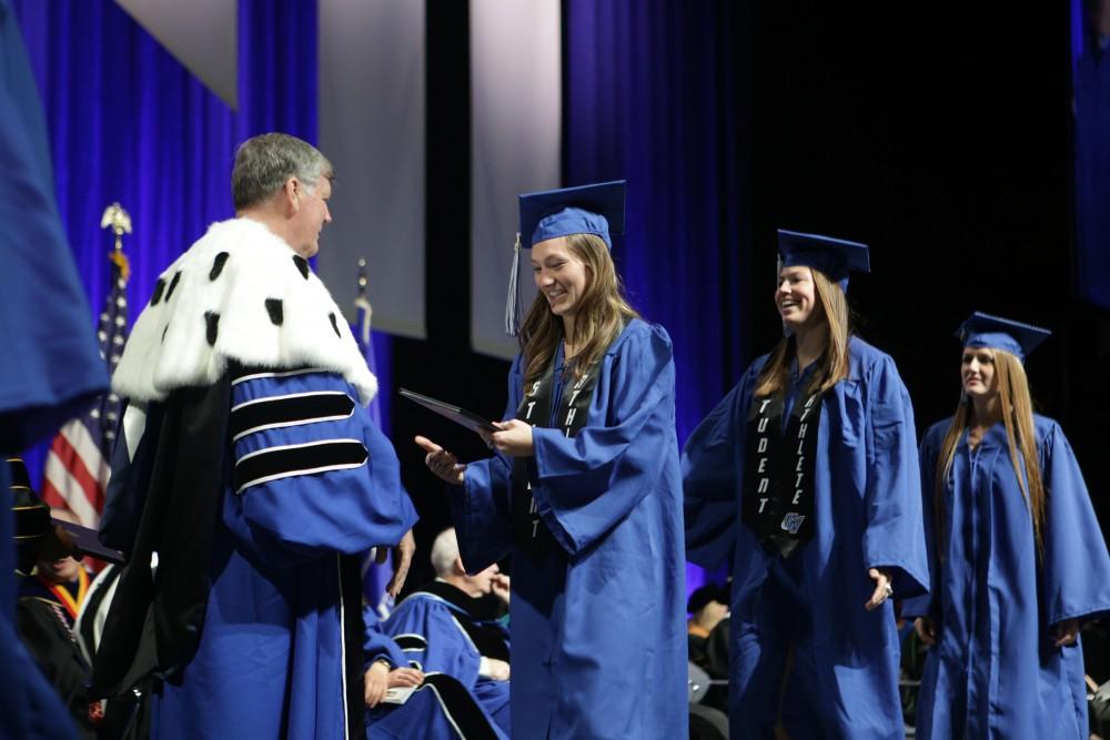 GVL / Emily FryeGrand Valley State University student Clare Carlson receiving her diploma during graduation on Saturday April 29, 2017.