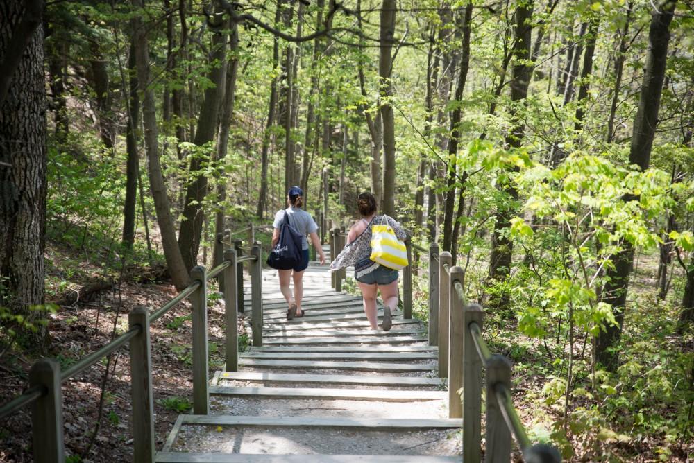 GVL / Luke Holmes - Visitors hike down the steps to the lake. Rosy Mound Natural Area in Grand Haven offers a short hike with great views of Lake Michigan, May 16, 2017.