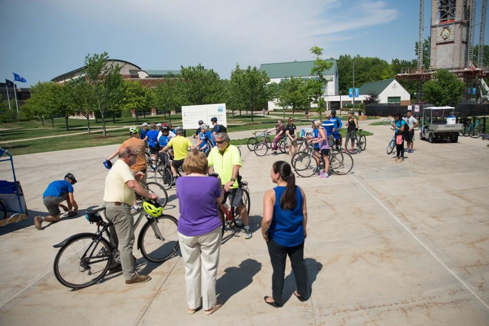 GVL / Luke Holmes - Students and faculty gather outside the Mary Idema Pew Library on their bikes. Bike Ride With T Haas was held Monday, June 12, 2017 to kickoff Active Commute Week.